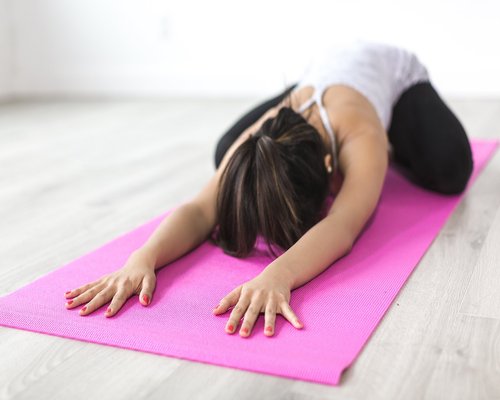 woman doing yoga in morning sunlight lifestyle